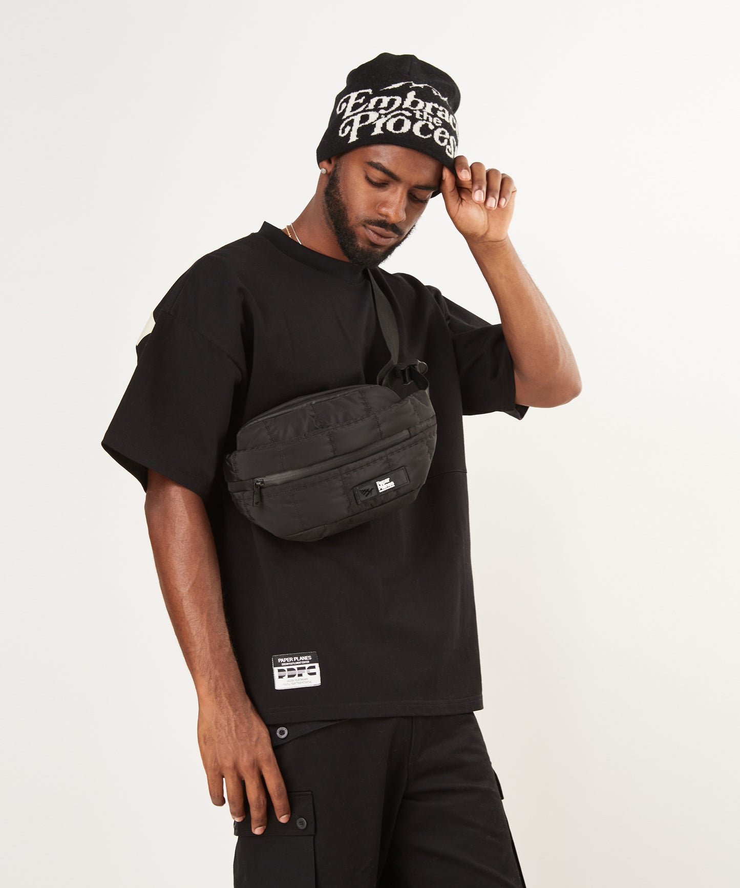 CUSTOM_ALT_TEXT: Male model wearing Paper Planes Embrace the Process Beanie.