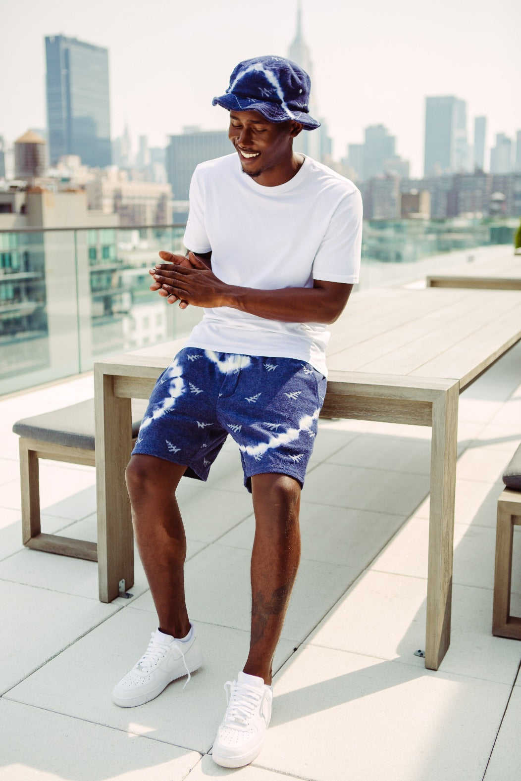 CUSTOM_ALT_TEXT: Male model wearing Paper Planes Tie Dye Jacquard Terry Cloth Bucket Hat color Navy.