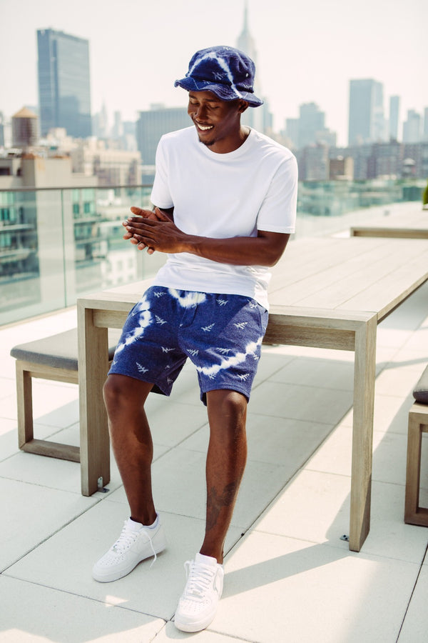 CUSTOM_ALT_TEXT: Male model wearing Paper Planes Tie Dye Jacquard Terry Cloth Bucket Hat color Navy.