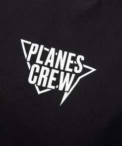 CUSTOM_ALT_TEXT: Front print closeup on Paper Planes Winning Team Tee, color Black.
