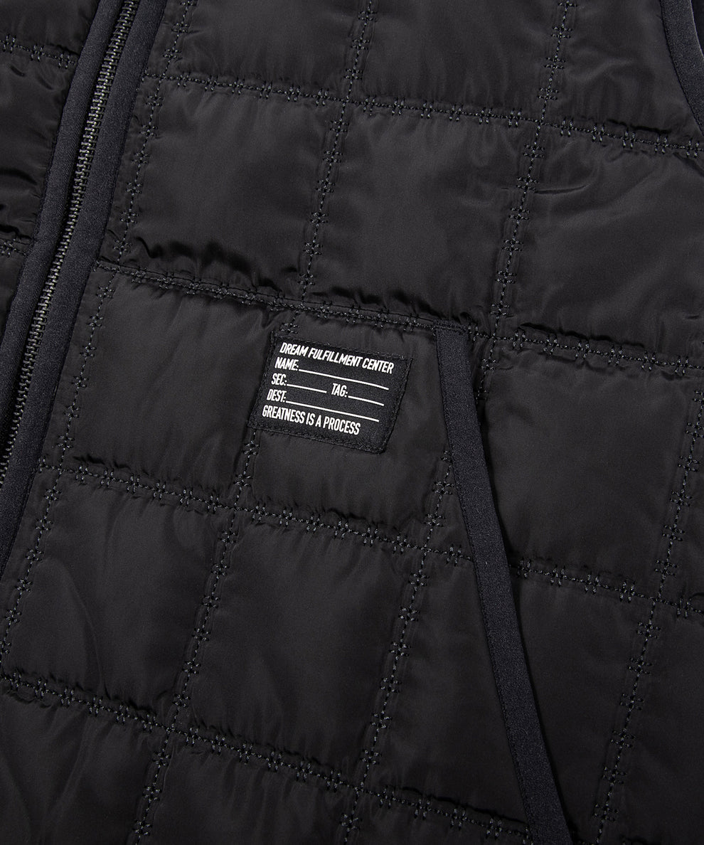 CUSTOM_ALT_TEXT: Silicone printed woven patch on  Paper Planes All-Purpose Quilted Vest, color Black.