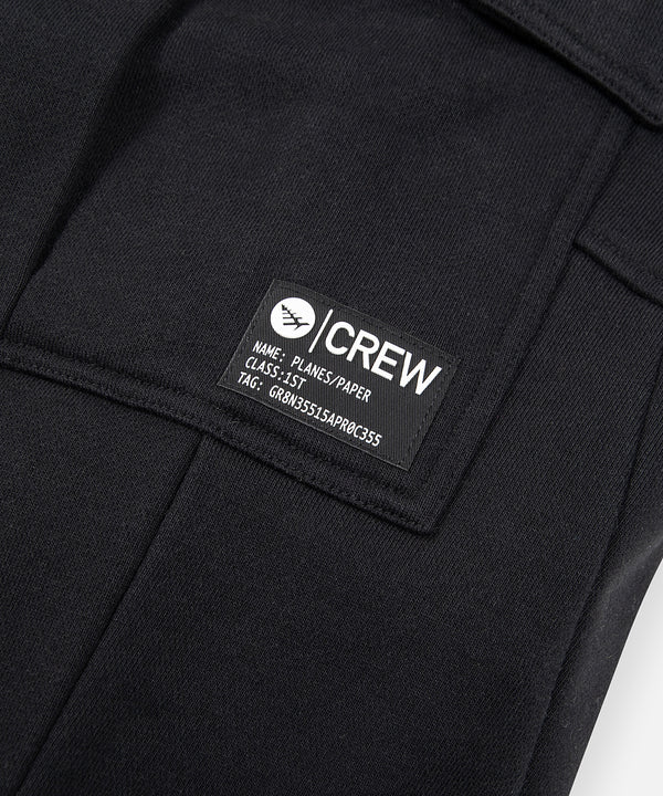 CUSTOM_ALT_TEXT: Silicone-printed patch on Paper Planes Super Cargo Sweatpant, color Black.