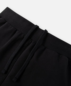 CUSTOM_ALT_TEXT: Elasticated waistband with hidden interior drawcord on Paper Planes Slim Fit Sweatpant, color Black.