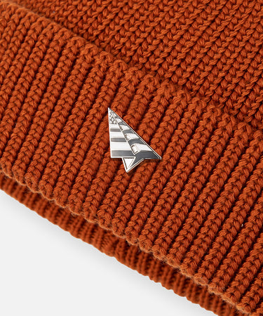 CUSTOM_ALT_TEXT: Plane pin on front brim of Paper Planes Wharfman Beanie, color Ginger.