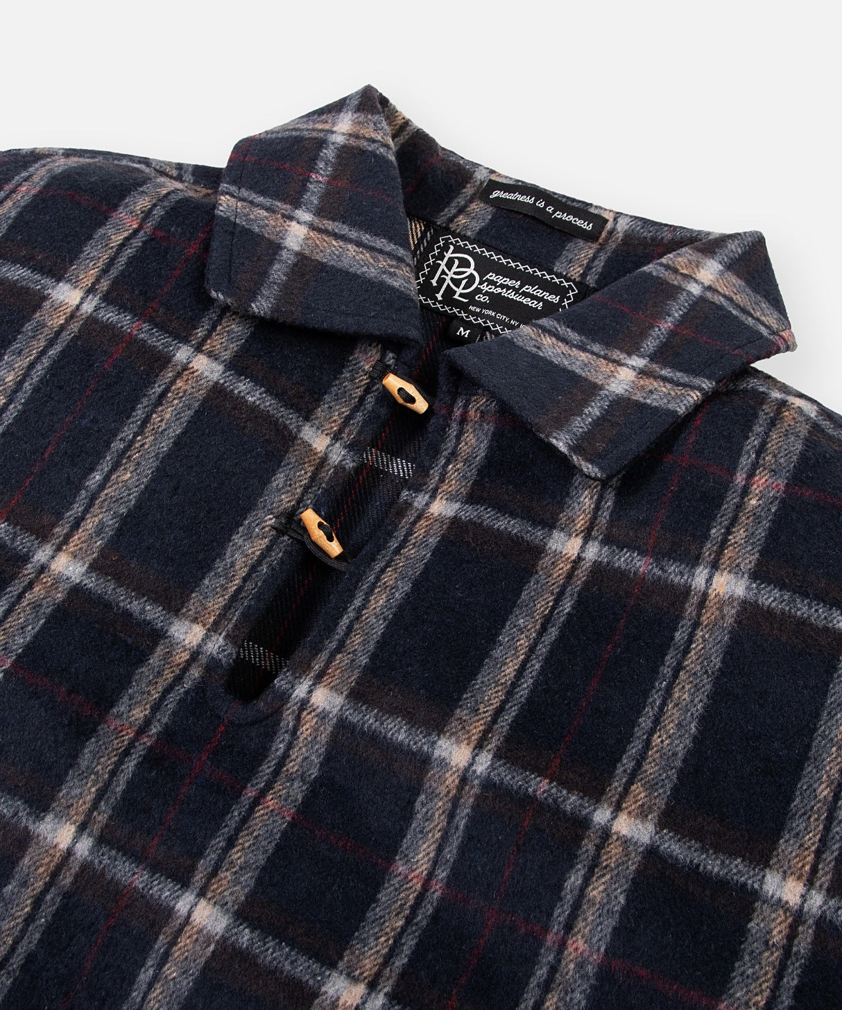 CUSTOM_ALT_TEXT: Collar with split neck and wooden toggle closure on Paper Planes Plaid Brushed Flannel Tunic.