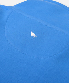  High-density silicone Plane icon centered on half moon stitch at back of Paper Planes Open Hem Half Zip Sweatshirt, color Azure Blue.