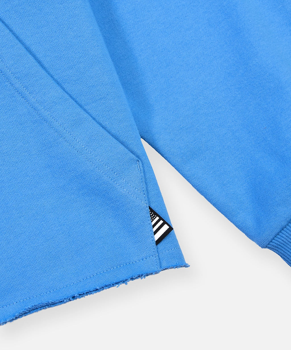  Paper Plane flag label on kangaroo pocket edge and raw hem on Paper Planes Open Hem Half Zip Sweatshirt, color Azure Blue.