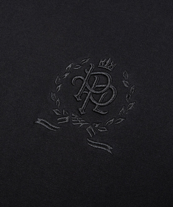 CUSTOM_ALT_TEXT: 3-D embroidered PPL chest crest on Paper Planes Crest Hoodie, color Black.