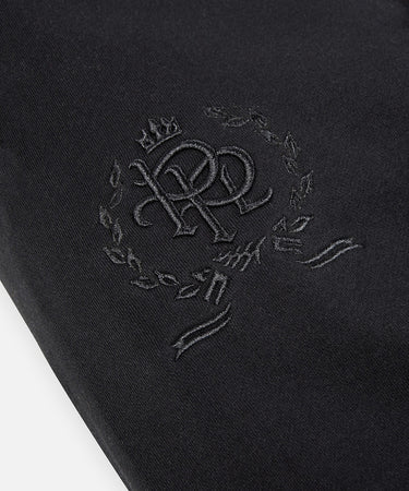 CUSTOM_ALT_TEXT: 3-D embroidered PPL crest on right thigh of Paper Planes Crest Sweatpant, color Black.