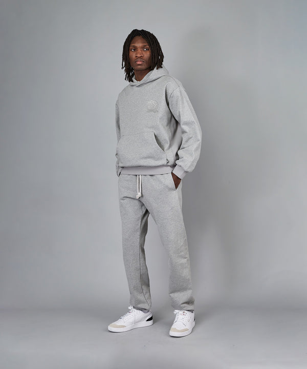 CUSTOM_ALT_TEXT: Model wearing Paper Planes Crest Hoodie and Sweatpant, color Heather Grey.