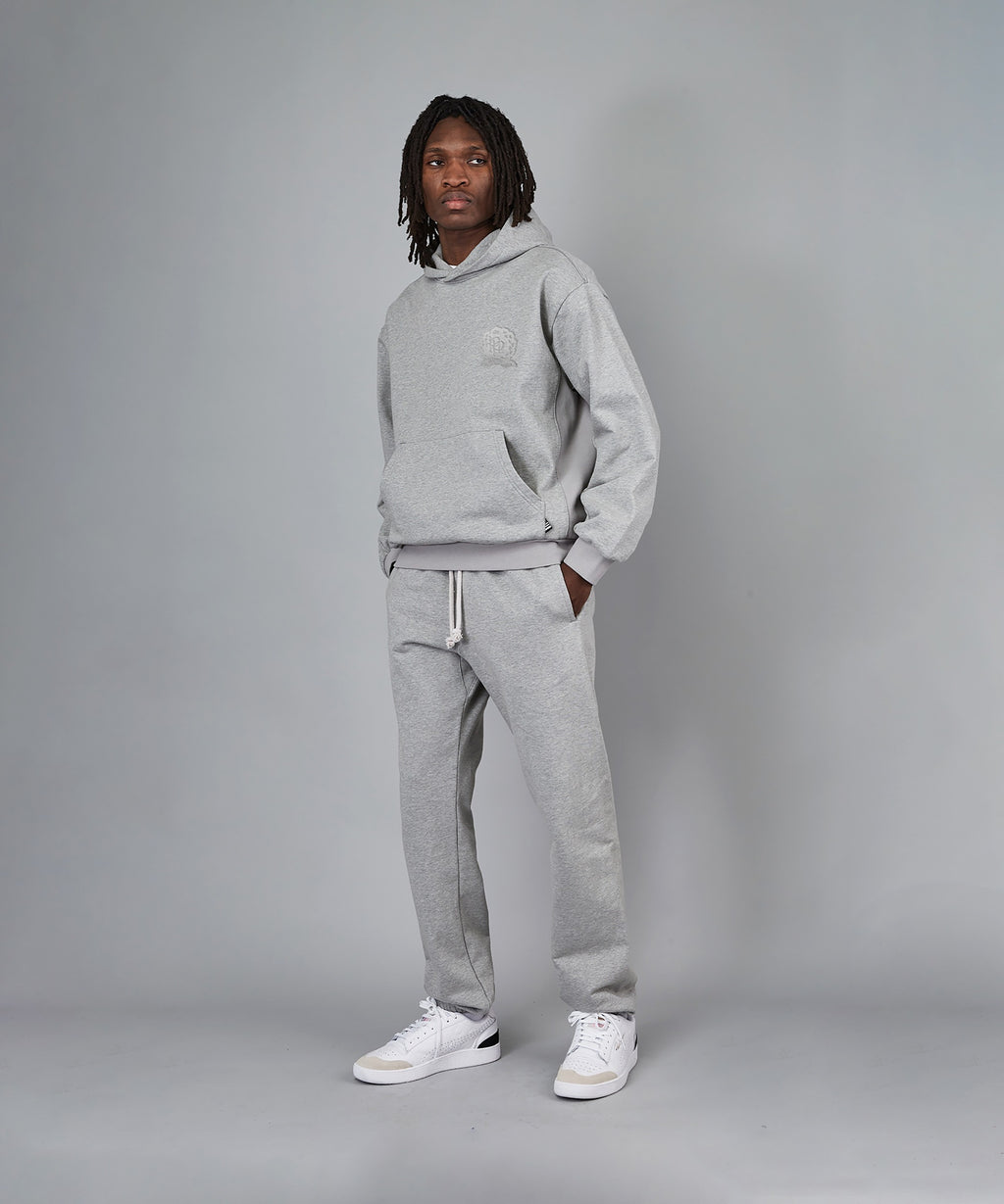  Model wearing Paper Planes Crest Hoodie and Sweatpant, color Heather Grey.