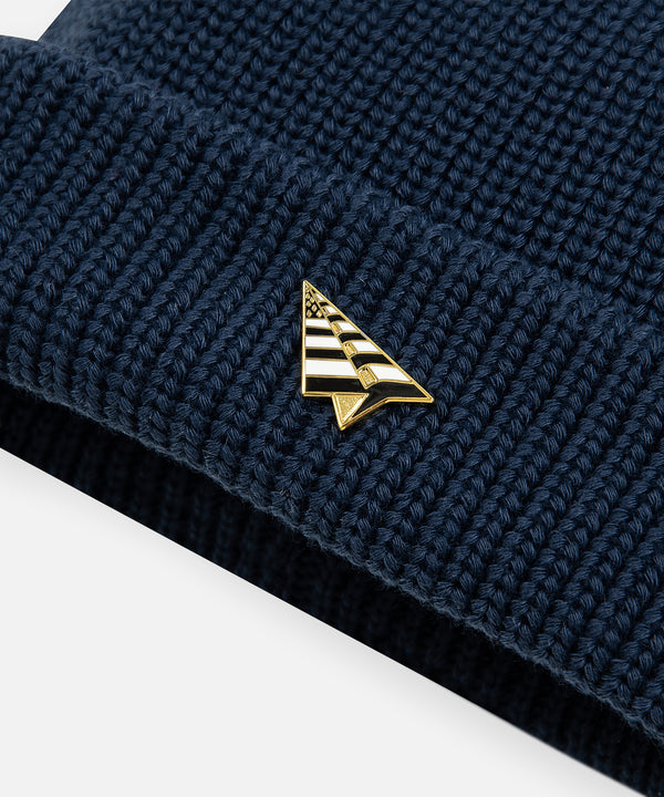 CUSTOM_ALT_TEXT: Gold plated plane pin on Paper Planes Wharfman Beanie, color Navy.