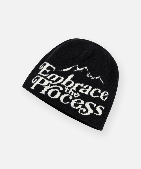 CUSTOM_ALT_TEXT: Angled view of Paper Planes Embrace the Process Beanie.