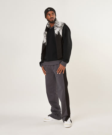 CUSTOM_ALT_TEXT: Male model wearing Paper Planes Dream Lab Sweatshirt and Sweatpant.