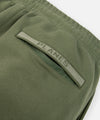 CUSTOM_ALT_TEXT: Tonal jacquard flat knit rib back welt pocket on Paper Planes Logo Jacquard Pant, color Bronze Green.