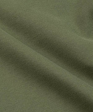 CUSTOM_ALT_TEXT: Closeup of heavyweight French terry on Paper Planes Logo Jacquard Pant, color Bronze Green.