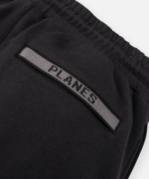 CUSTOM_ALT_TEXT: Tonal jacquard flat knit rib back welt pocket on Paper Planes Logo Jacquard Pant, color Black.