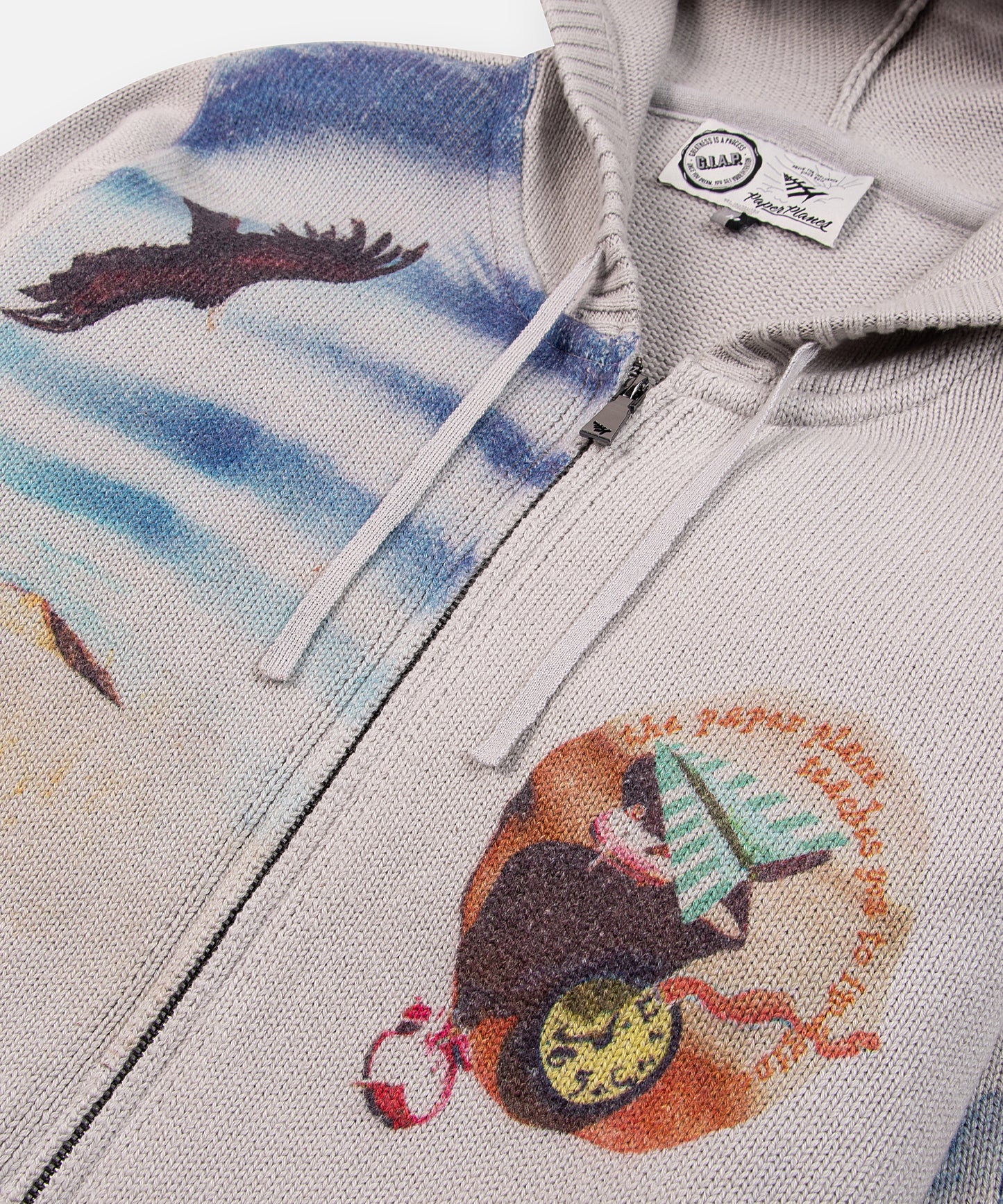 CUSTOM_ALT_TEXT: Front detail with zipper closure and hood drawcord on Paper Planes Printed Sweater Zip-Up Hoodie.