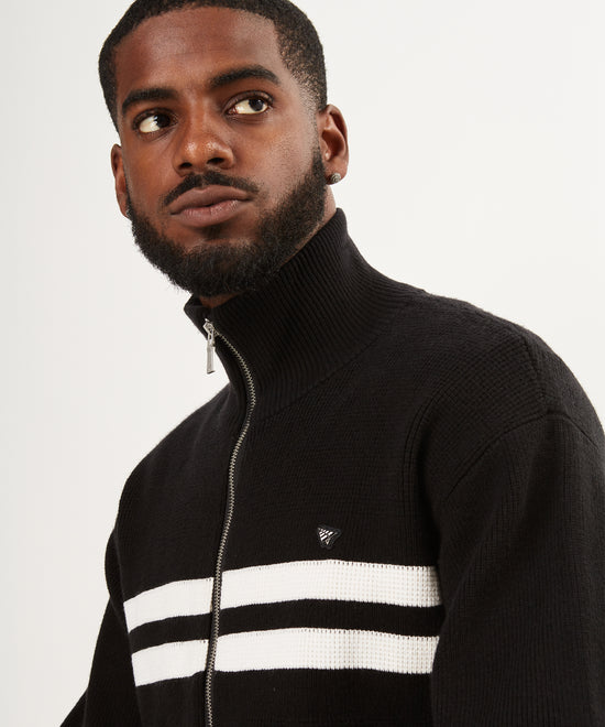 CUSTOM_ALT_TEXT: Male model wearing Paper Planes Sweater Track Jacket, color Black.