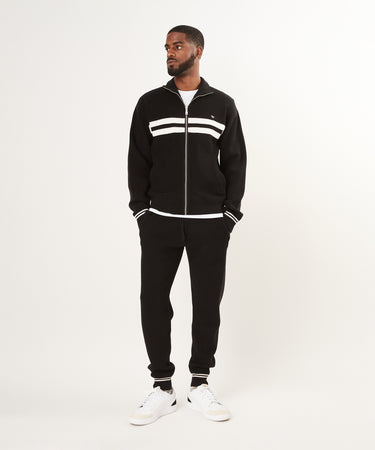 CUSTOM_ALT_TEXT: Male model wearing Paper Planes Sweater Track Jacket and Jogger set, color Black.