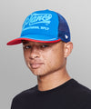 CUSTOM_ALT_TEXT: Male model wearing Planes Greatness Trucker Hat color Nautical Blue.