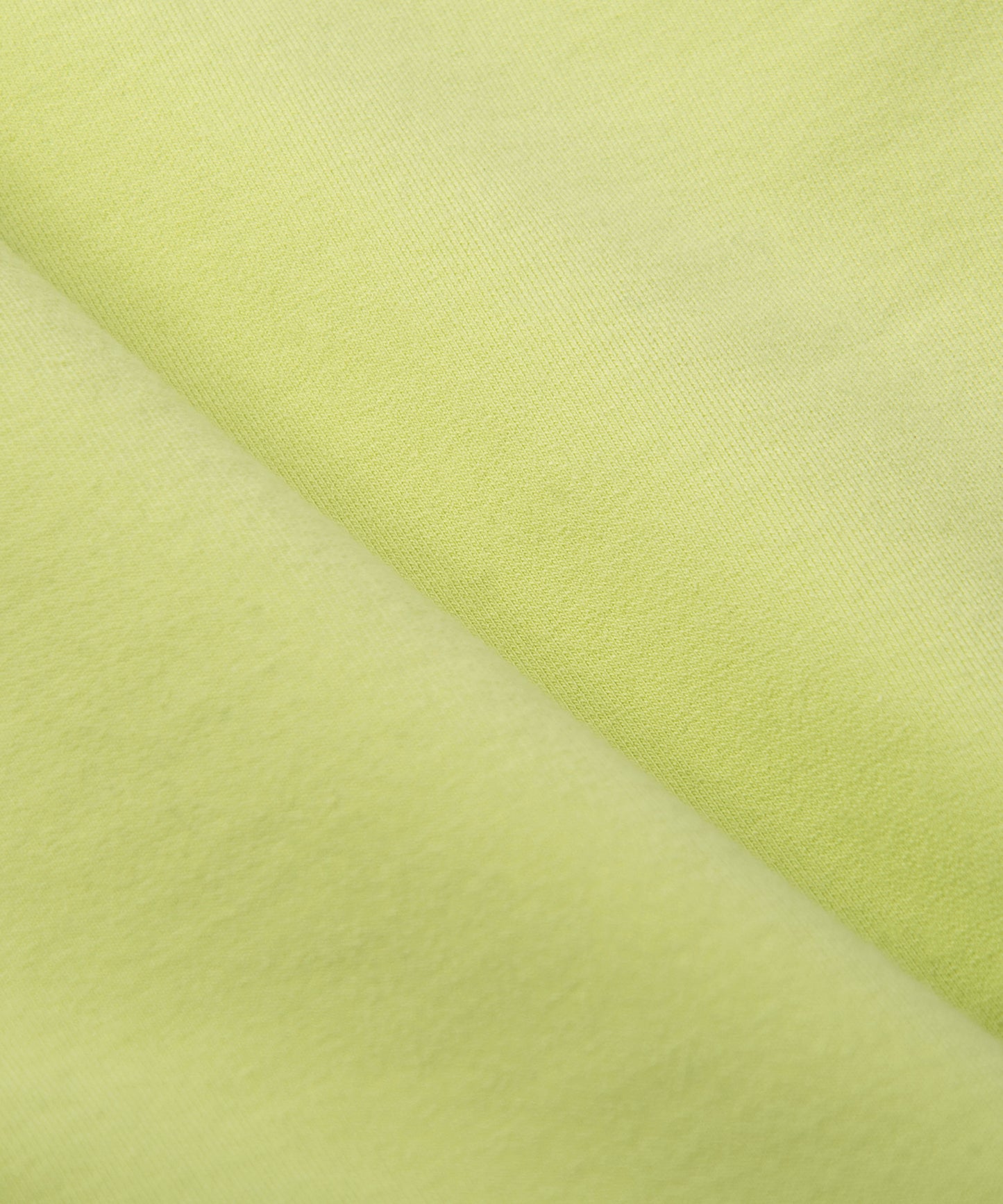 CUSTOM_ALT_TEXT: French terry closeup on Paper Planes Gusset Short color Lime Sherbet.