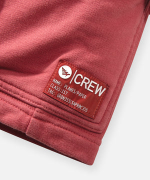 CUSTOM_ALT_TEXT: Planes Crew woven patch on Paper Planes Super Cargo Knit Short color Mineral Red.