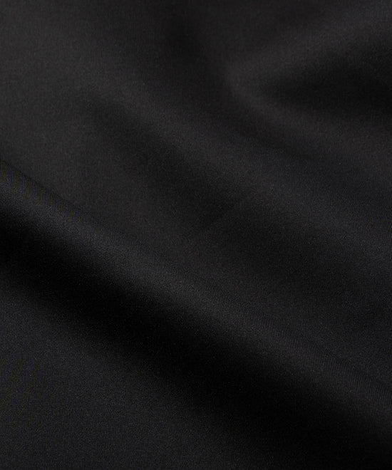 CUSTOM_ALT_TEXT: Fabric closeup on Paper Planes Greatness Is a Process Zip-Up Hoodie, color Black.