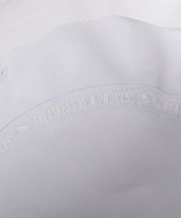 CUSTOM_ALT_TEXT: GREATNESS IS A PROCESS interior taping on Paper Planes Jacquard Terry Cloth Bucket Hat color White.
