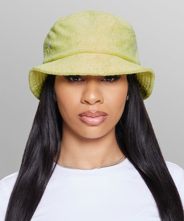 CUSTOM_ALT_TEXT: Female model wearing Paper Planes Jacquard Terry Cloth Bucket Hat color Lime Sherbet.