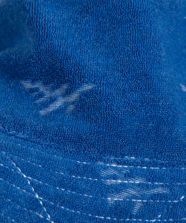 CUSTOM_ALT_TEXT: Fabric closeup of Paper Planes Jacquard Terry Cloth Bucket Hat color Nautical Blue.