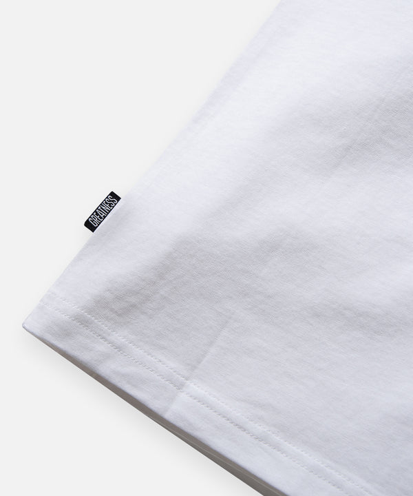 CUSTOM_ALT_TEXT: GREATNESS IS A PROCESS woven label on Paper Planes Essential 3-Pack Tee, color White.