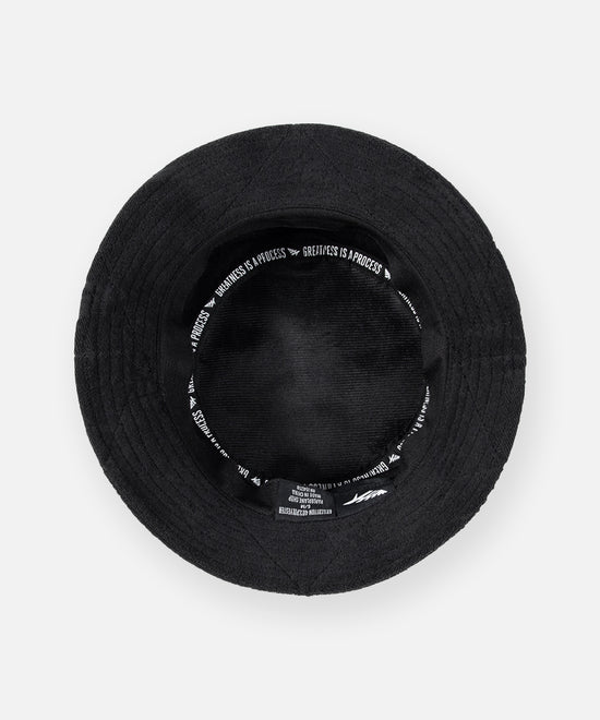CUSTOM_ALT_TEXT: GREATNESS IS A PROCESS interior taping on Paper Planes Jacquard Terry Cloth Bucket Hat color Black.