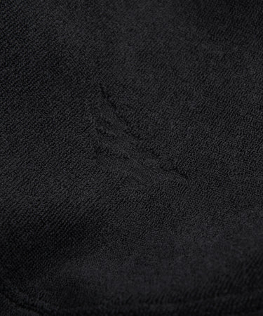 CUSTOM_ALT_TEXT: Fabric closeup of Paper Planes Jacquard Terry Cloth Bucket Hat color Black.